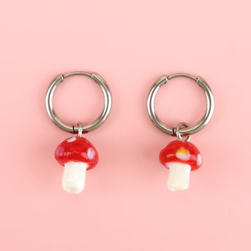 Silver hoop earrings with red toadstool charms