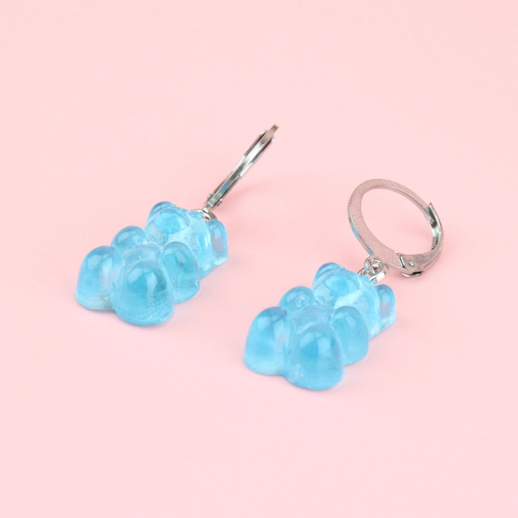 Blue gummy bear charms on stainless steel huggie hoops