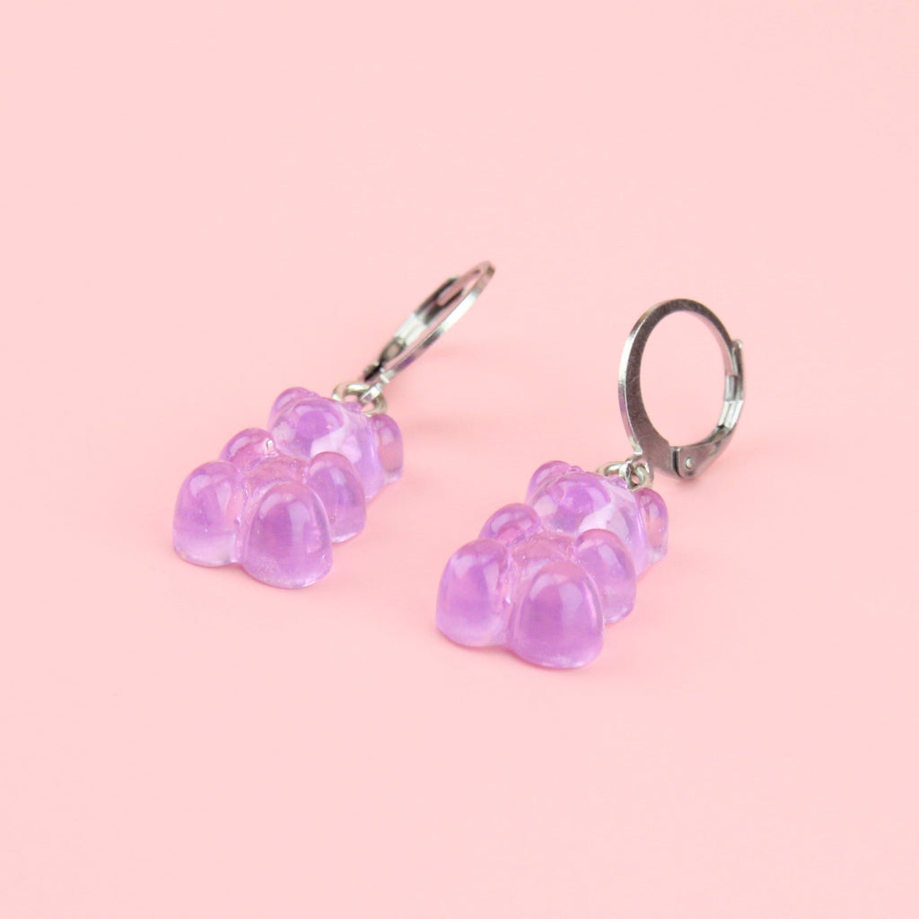 Lilac gummy bear charms on stainless steel huggie hoops