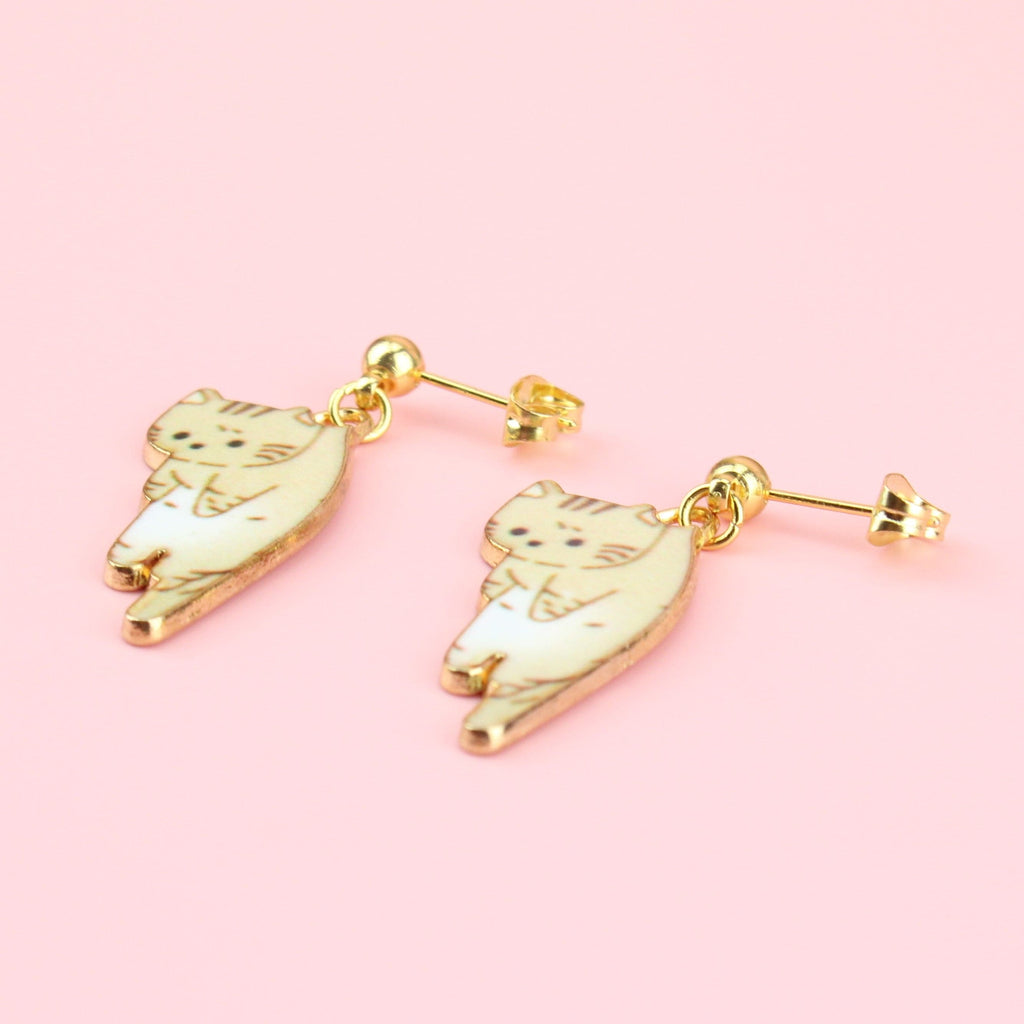 Fawn cat earrings hanging from gold plated stainless steel studs with a ball at the front
