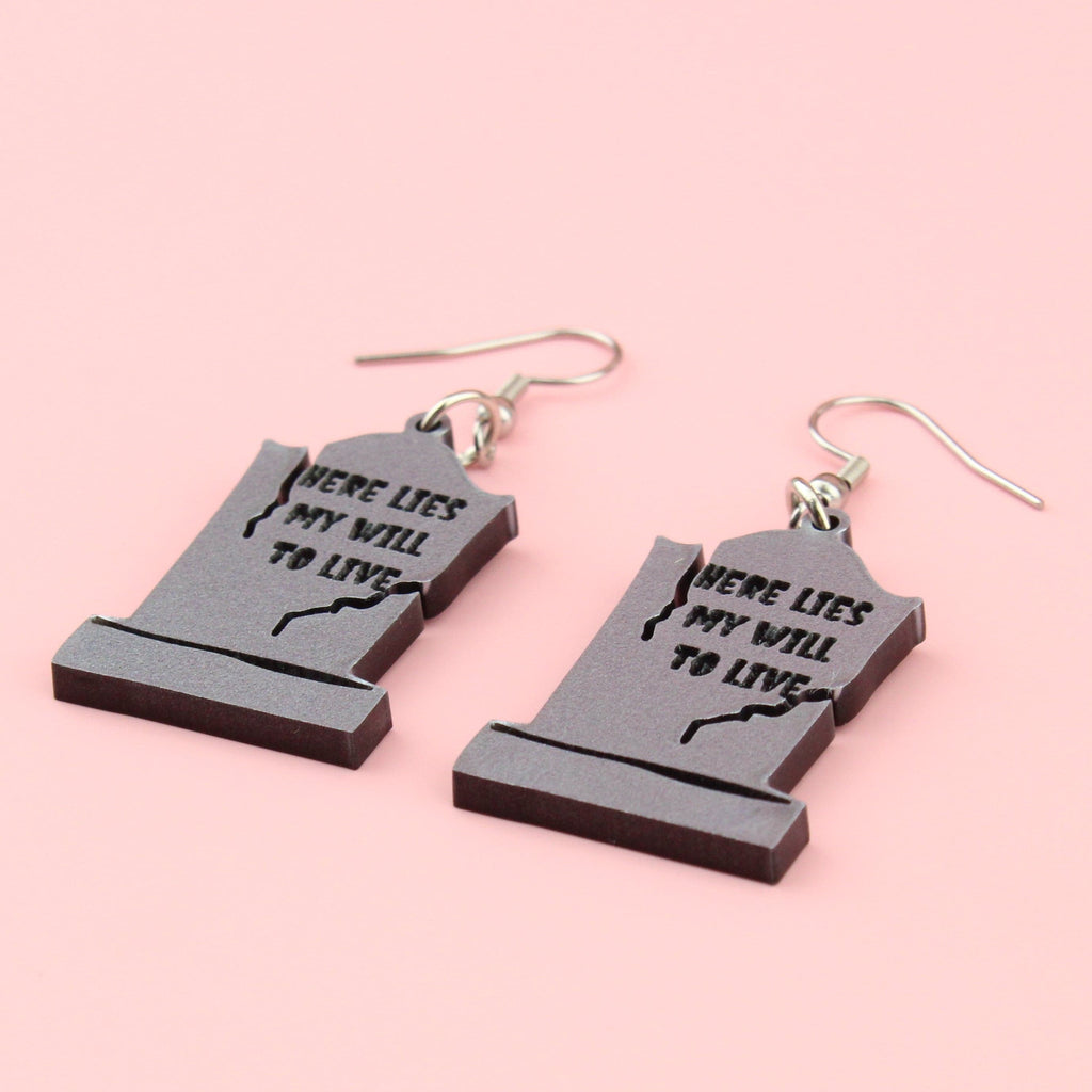 Grave stone charms with "Here lies my will to live" engraved on the grave stone, on stainless steel earwires