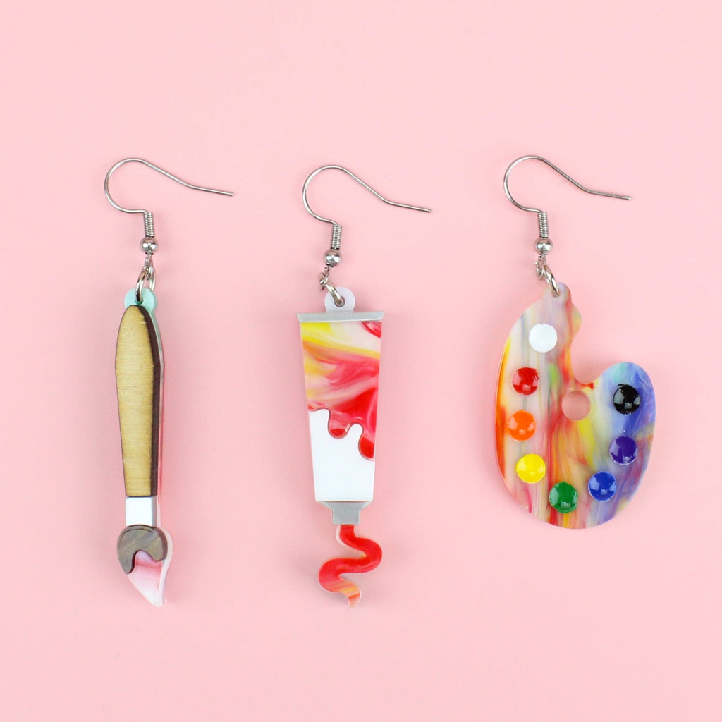 3 pack of earrings - Paint brush earring, Paint tube earring showing paint coming out of the tube, and an art pallette earring (all on stainless steel earwires)