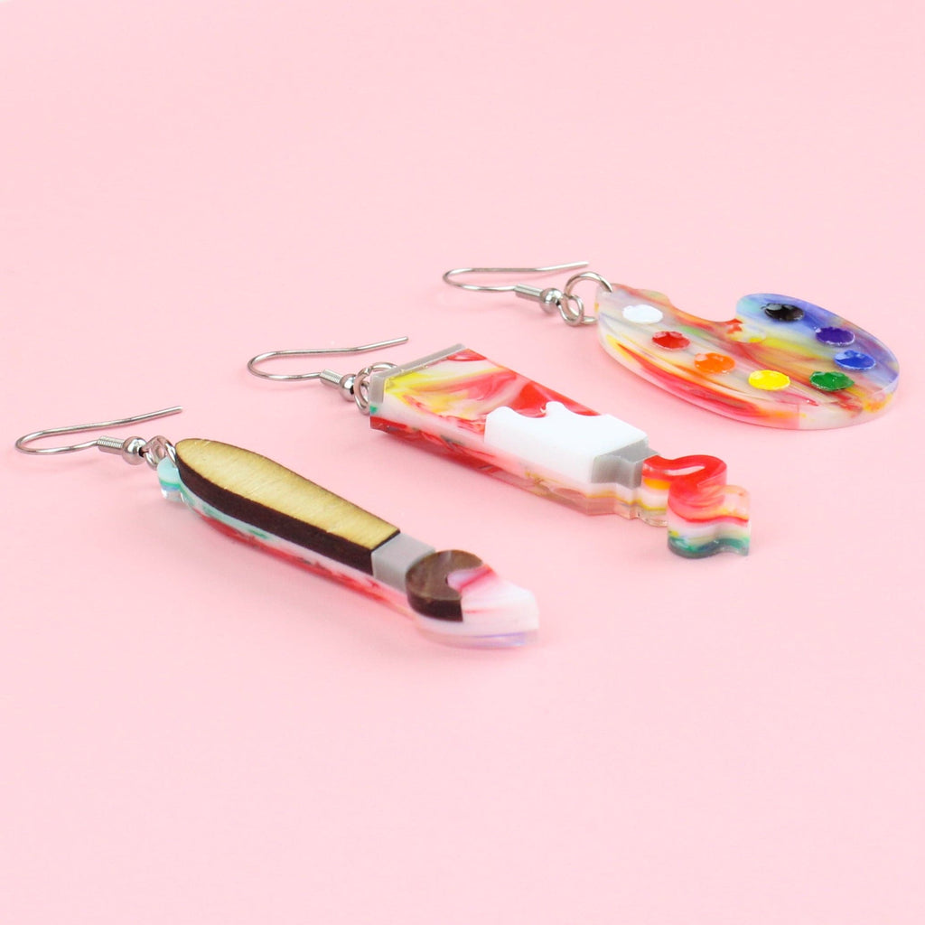 3 pack of earrings - Paint brush earring, Paint tube earring showing paint coming out of the tube, and an art pallette earring (all on stainless steel earwires)