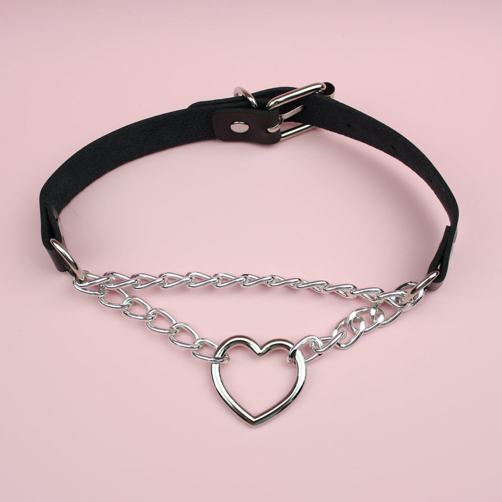 Black faux leather strap with a double chain and cut out heart