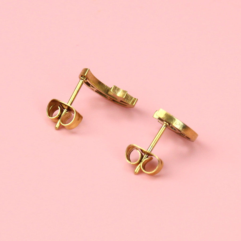 Gold plated stainless steel cut out moon studs with two stars in the moon and one large star on top of the inner cornr of the moon