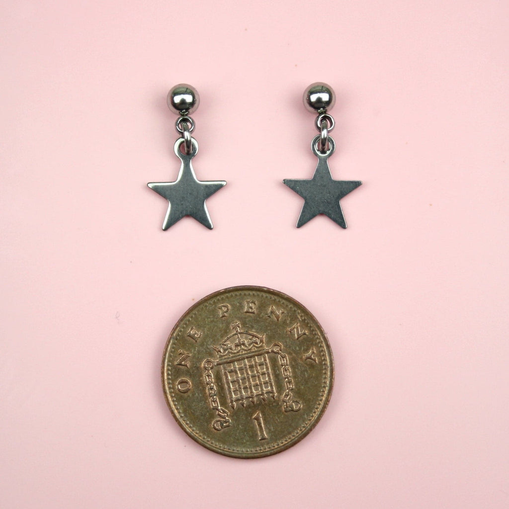 Stainless Steel Studs with Star Charms and a penny beneath the earrings for scale