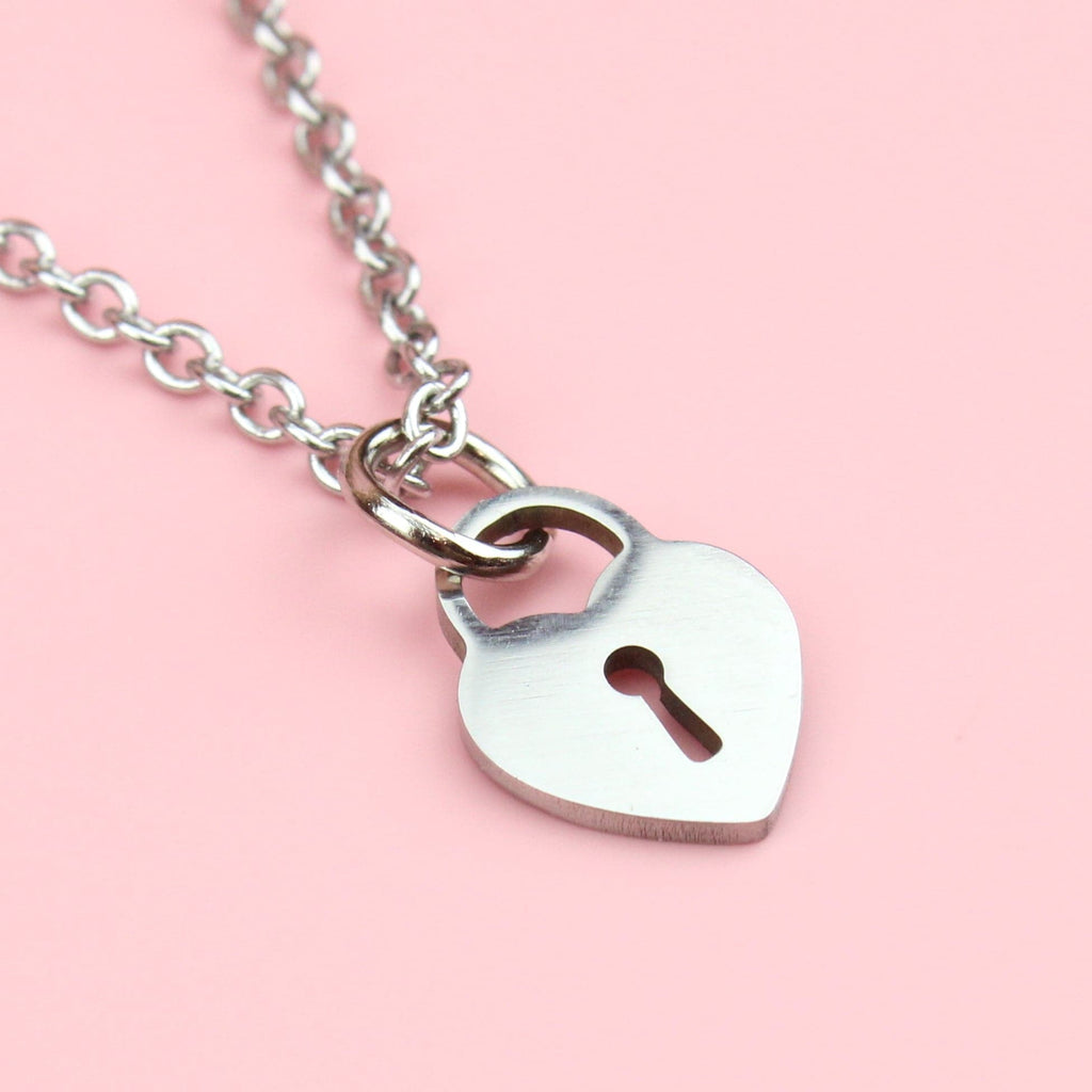 Stainless steel necklace featuring a heart-shaped padlock
