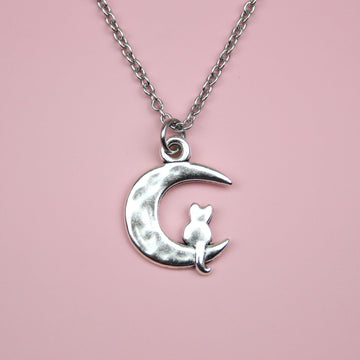 Stainless steel chain featuring a crescent moon pendant with a silhouette of a cat perced at the bottom of the moon