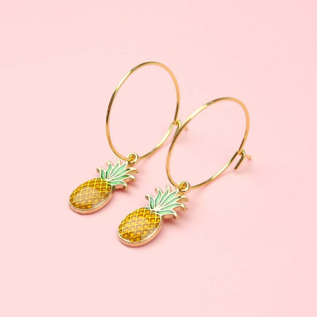 Gold hoop earrings featuring pineapple charms
