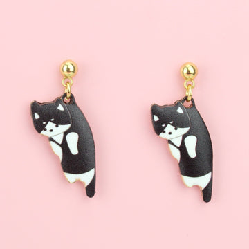 Black and white cat charms on gold plated stainless steel studs with a ball shaped stud at the top