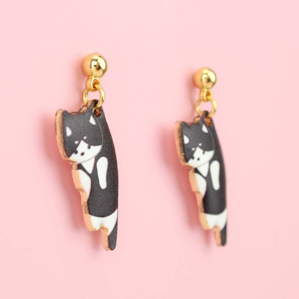 Black and white cat charms on gold plated stainless steel studs with a ball shaped stud at the top