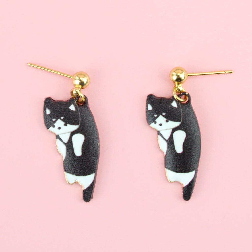 Black and white cat charms on gold plated stainless steel studs with a ball shaped stud at the top