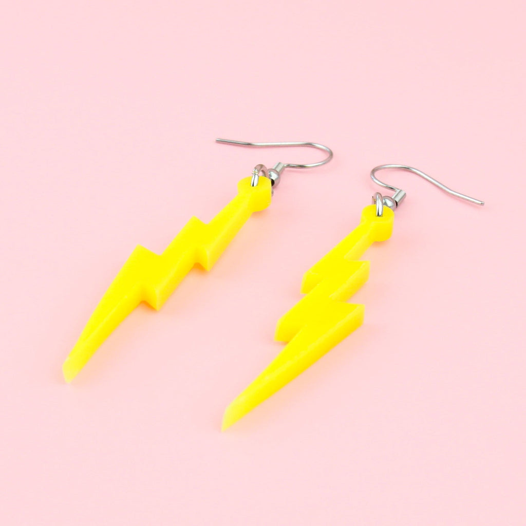 Laser cut yellow perspex lightning bolt charms on stainless steel earwires