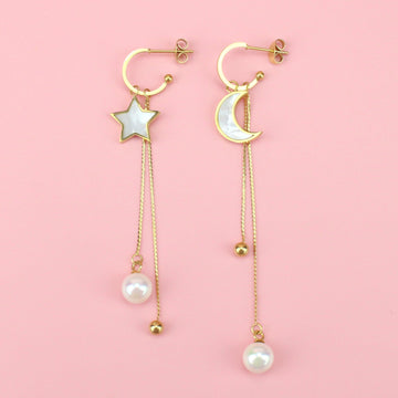 Gold plated star and moon charms with a gold plated stainless steel chain hanging from each earring with a pearl at the bottom of each earring