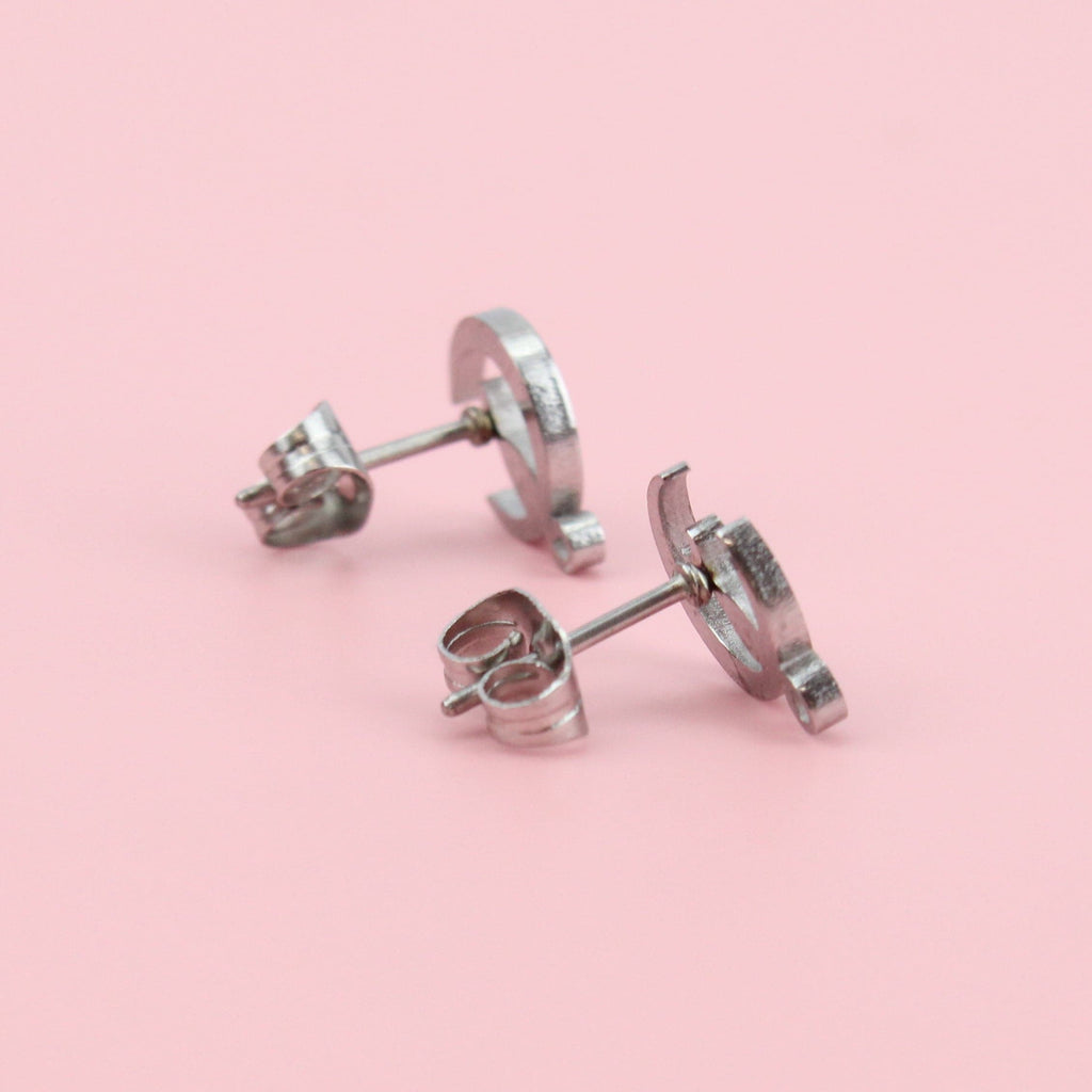 2 crescent moon studs with cats perched on the bottom of the moon