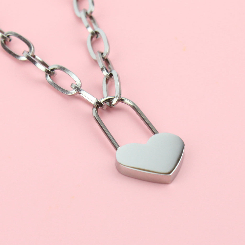 Oval chain stainless steel necklace with a heart lock charm