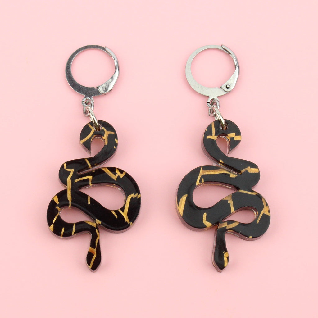 Black acrylic small black snake earrings with hints of gold foil on stainless steel hoops