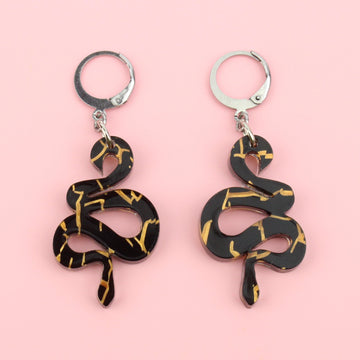 Black acrylic small black snake earrings with hints of gold foil on stainless steel hoops