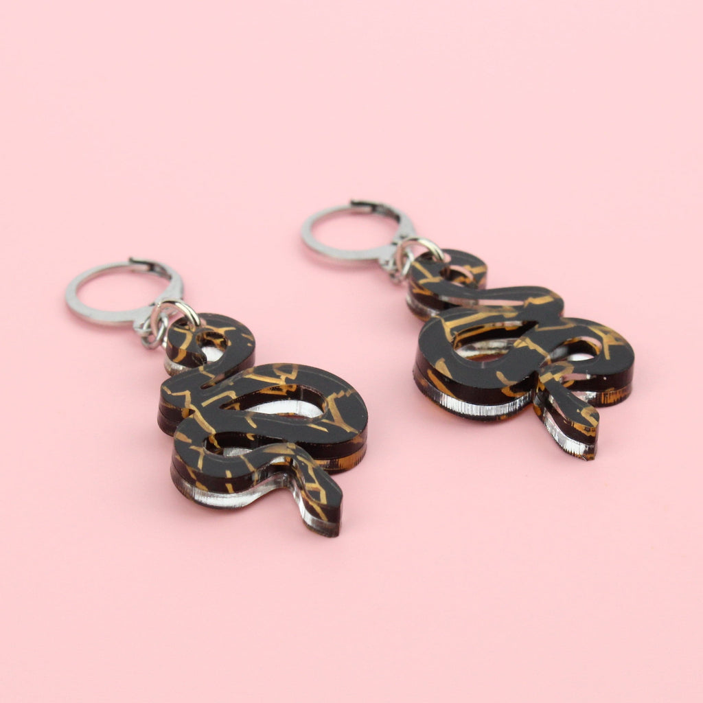 Black acrylic small black snake earrings with hints of gold foil on stainless steel hoops