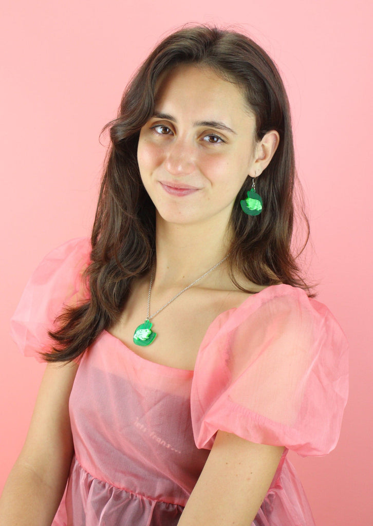 Model wearing frog necklace and matching earrings