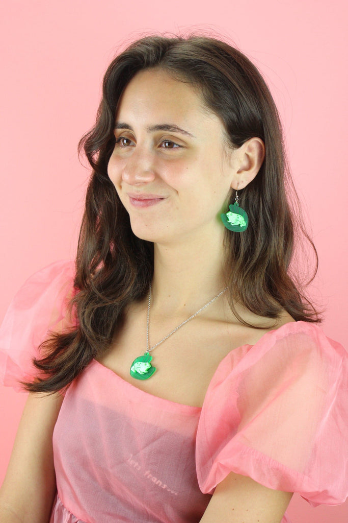 Model wearing frog necklace and matching earrings