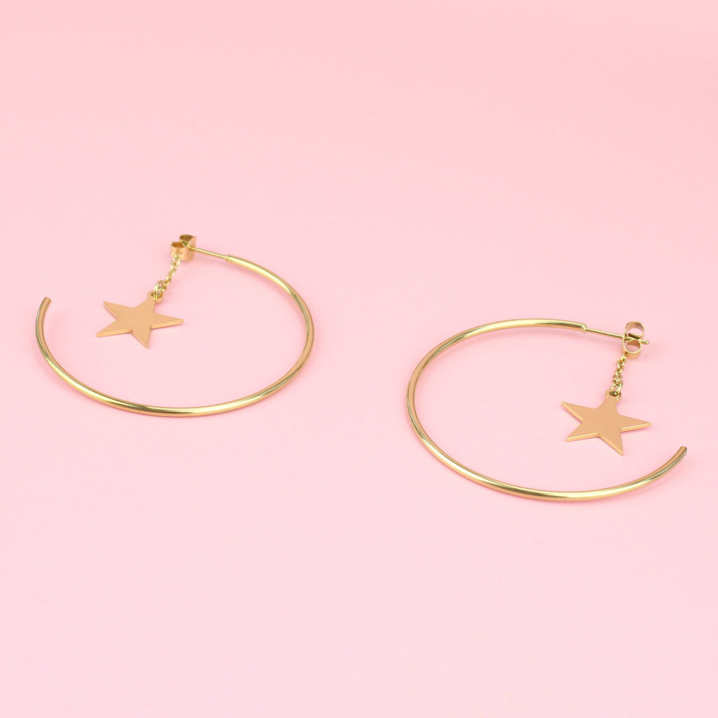 Gold plated stainlss steel hoop with a star dangling from the earring back