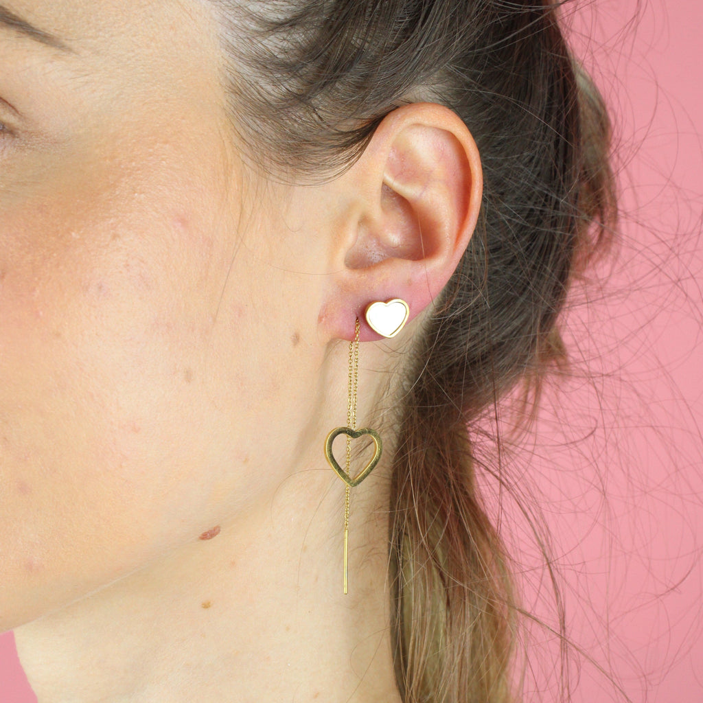 Ear wearing the Heart Shell Earrings and Heart Pull Through earrings (both gold plated)