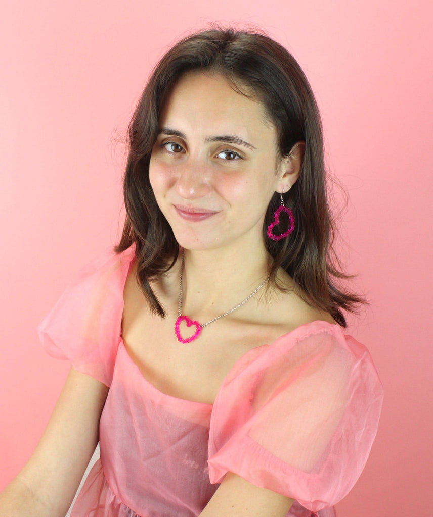 Model wearing Pink barbed WIre Heart Earrings with matching necklace