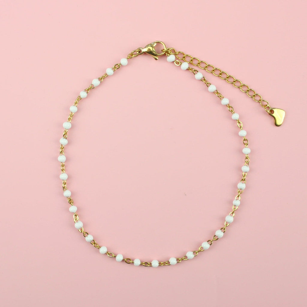 White beaded anklet on a gold plated stainless steel chain