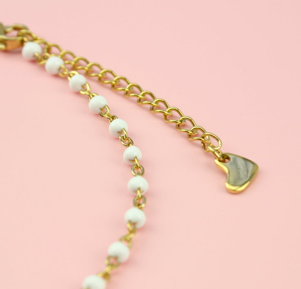 White beaded anklet on a gold plated stainless steel chain