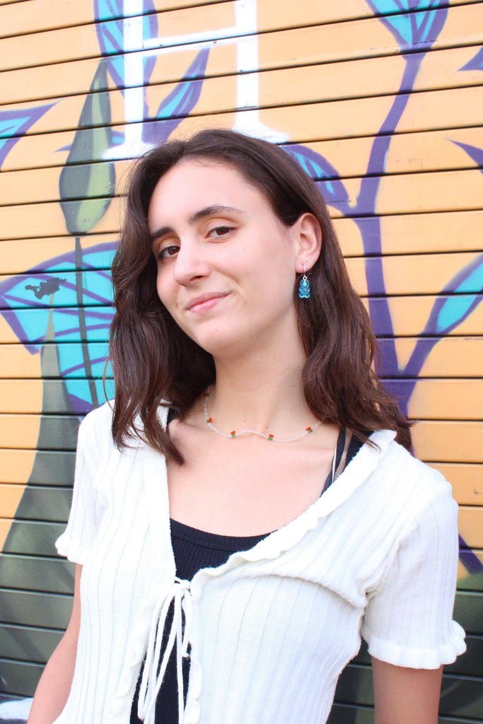 Model wearing gummy bear earrings in a different colour
