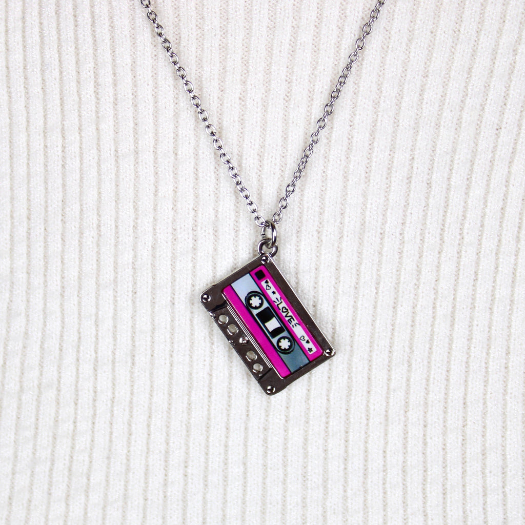 Stainess steel chain with a pendant featuring a mix tape titled the word 'love' surrounded by hearts, the top and bottom of the mix tape is pink