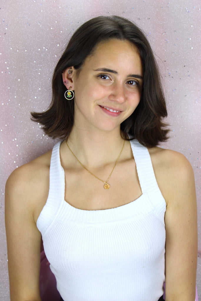 Model wearing Gold Plated Circle Charm with Cut Out Gemini Symbol on a Gold plated Stainless Steel chain