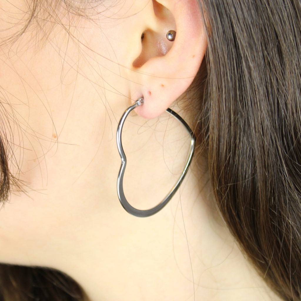 Model wearing Stainless Steel Heart shaped hoop earrings