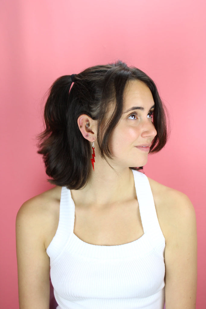 Model wearing Red Glitter Lightning Bolt Earrings 