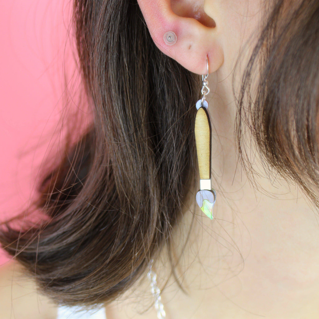 Model wearing the paint brush earring