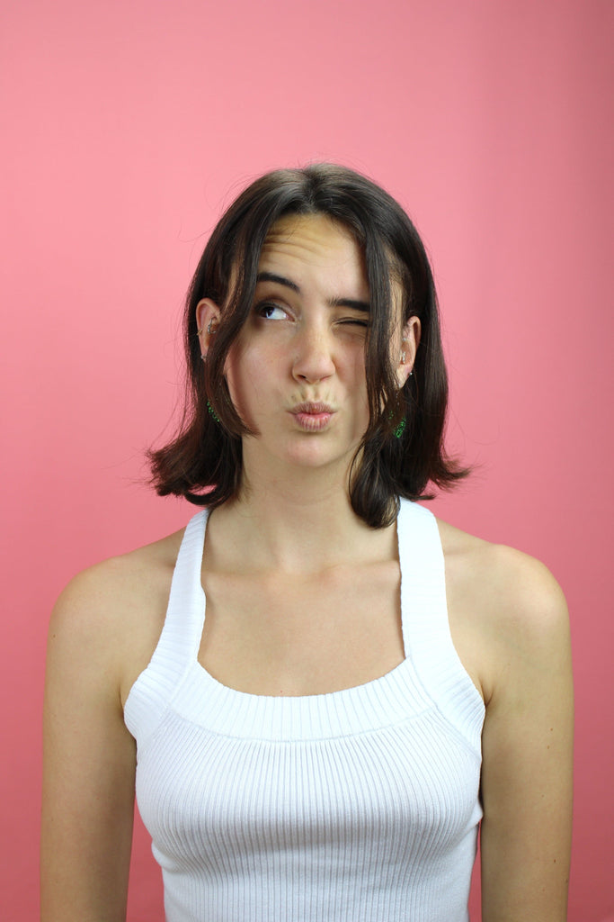 Model wearing Green glittery monstera charms on stainless steel earwires