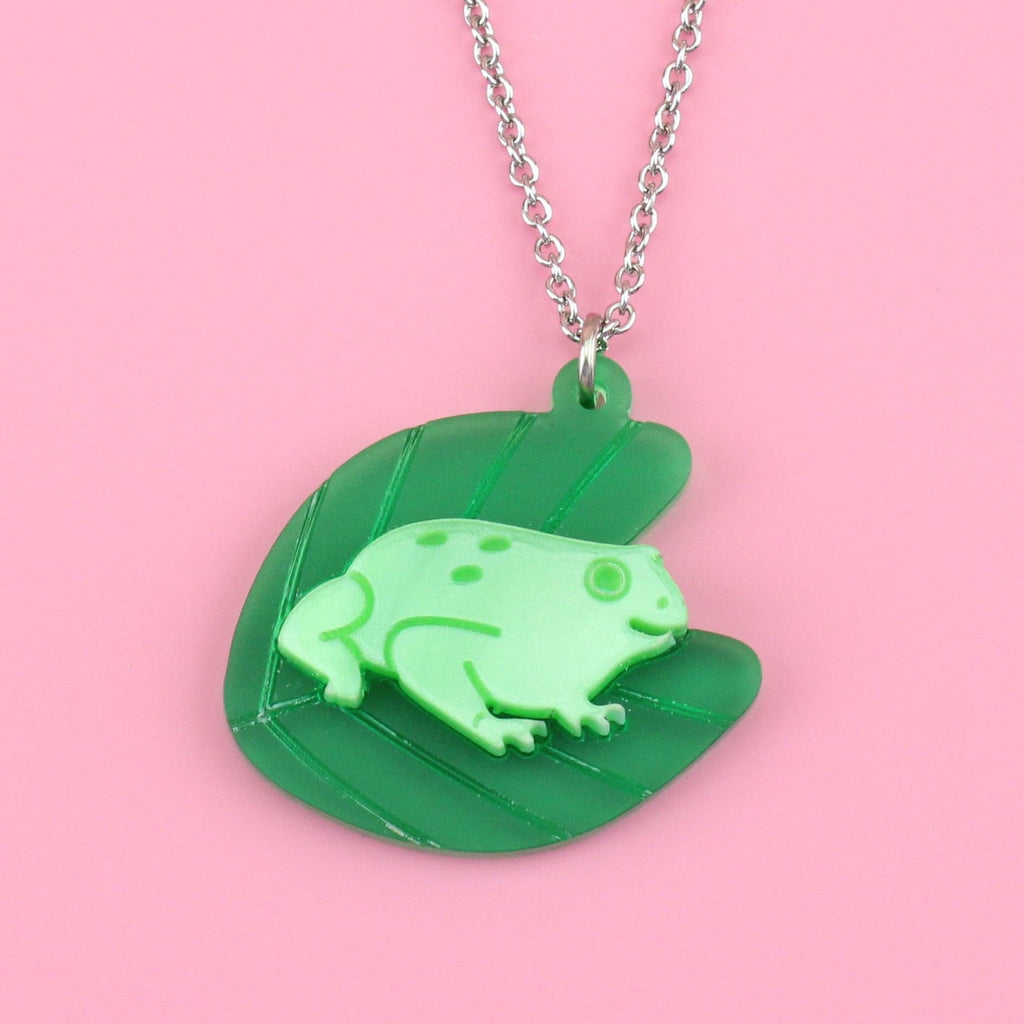 Green frog on a lily pad on a stainless steel chain