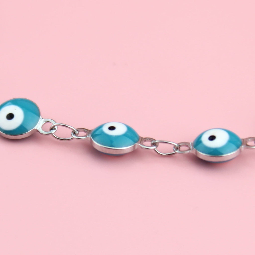 Blue enamelled eyes on a stainless steel bracelet
