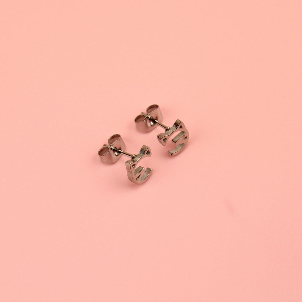 Stainless steel studs with a cut out cat face design