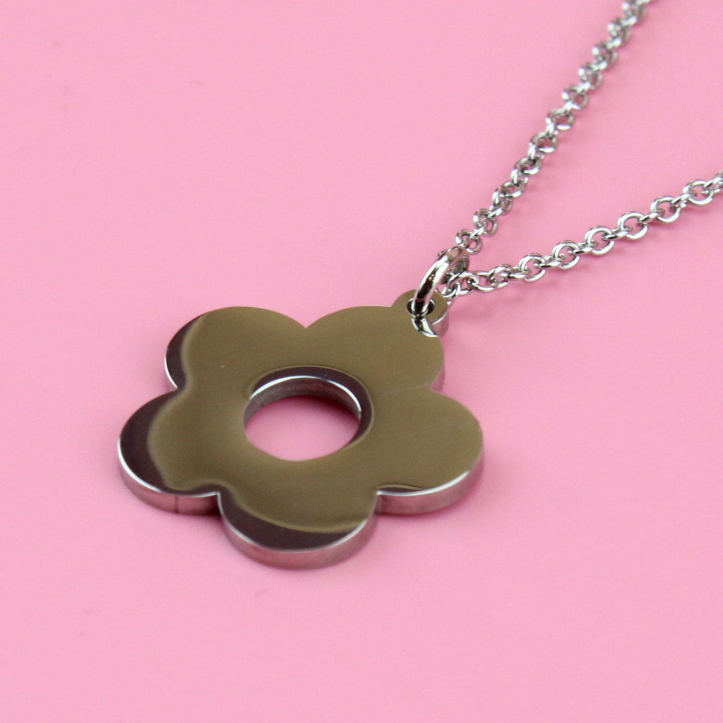 Stainless steel chain featuring flower charm with a cut out middle