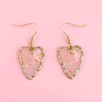 Gold tone heart setting filled with shades of pink resin and gold flecks on Gold plated stainless steel ear wires