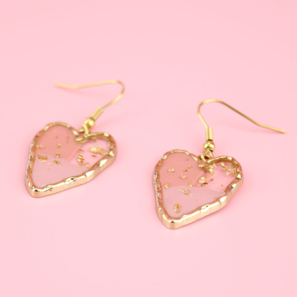 Gold tone heart setting filled with shades of pink resin and gold flecks on Gold plated stainless steel ear wires