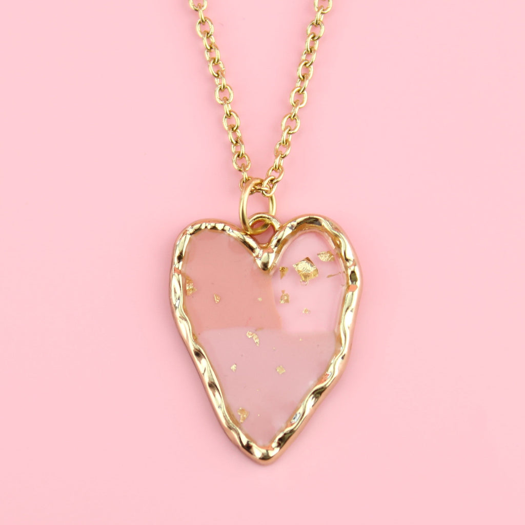 Gold plated stainless steel necklace with a gold heart pendant featuring 2 shades of pink in the middle and gold speck