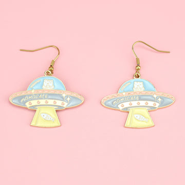 Gold plated UFO design charms on gold plated stainless steel earwires featuring hints of yellow, blue, pink and white 