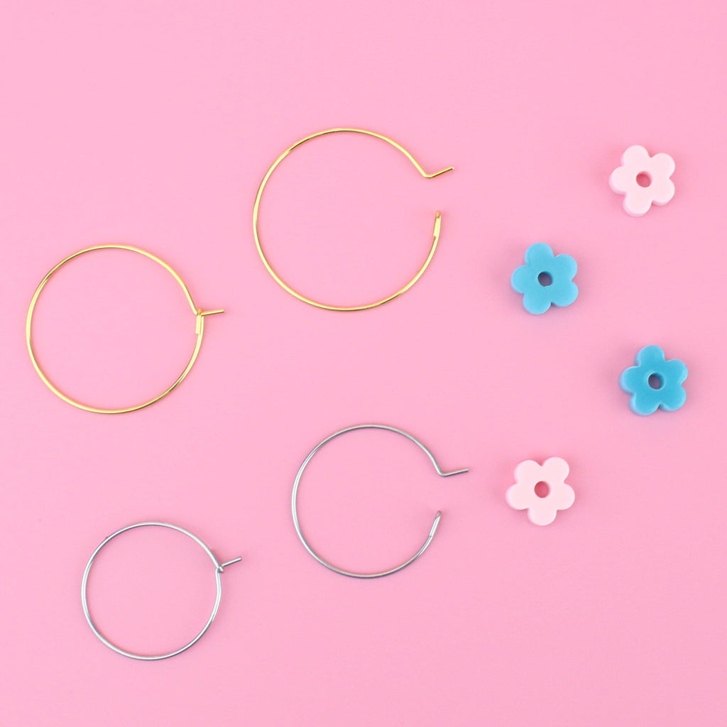 2 pack of hoop earrings - silver hoops with blue acrylic flower charms and gold hoops with baby pink acrylic flower charms