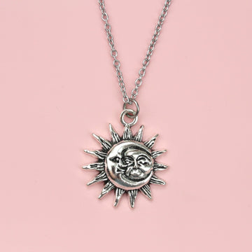 Moon and sun faces with a sun outline on a stainless steel chain