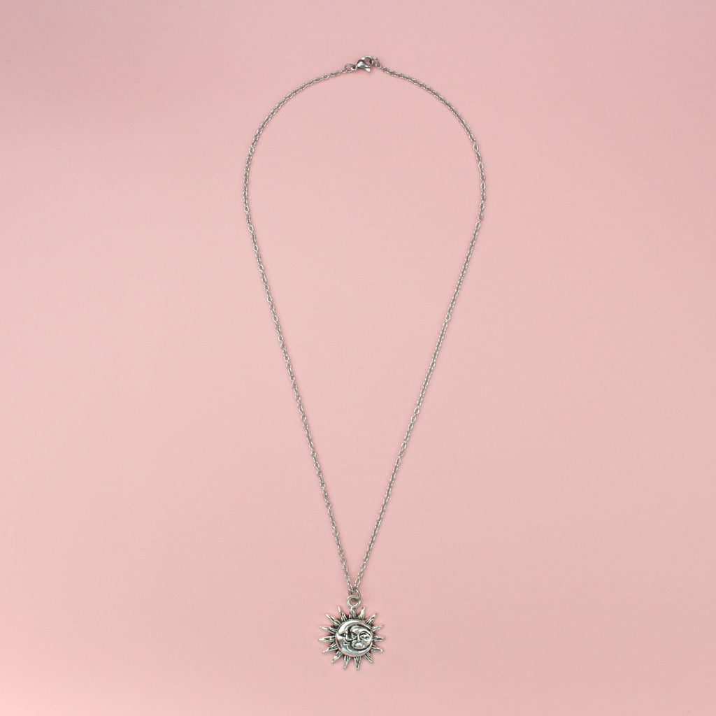 Moon and sun faces with a sun outline on a stainless steel chain
