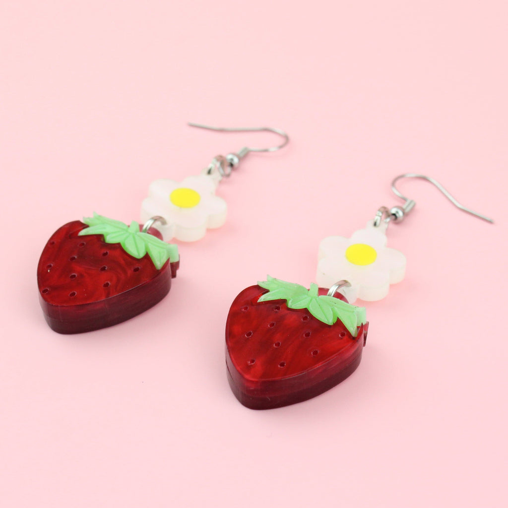 Acrylic strawberries hung from blossom charms on stainless steel earwires