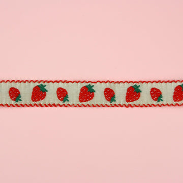 A strawberry print design on a white fabric choker with red edges 